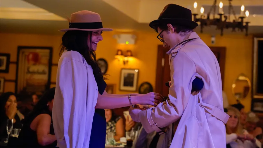 A Murder Mystery Company detective questioning a guest at a San Diego show